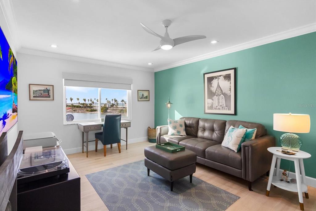 174 Golden Gate Point, Unit 32 Sarasota, FL 34236 - Photo 33 of 46 a living room with furniture and a flat screen tv