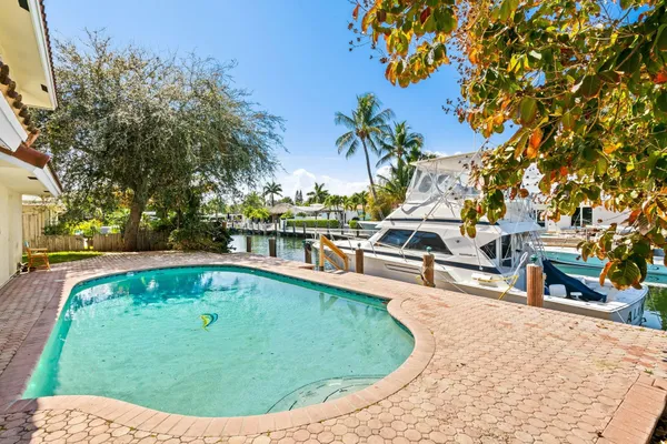 a view of a swimming pool with outdoor seating