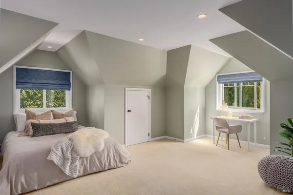 a bedroom with a large bed and a window