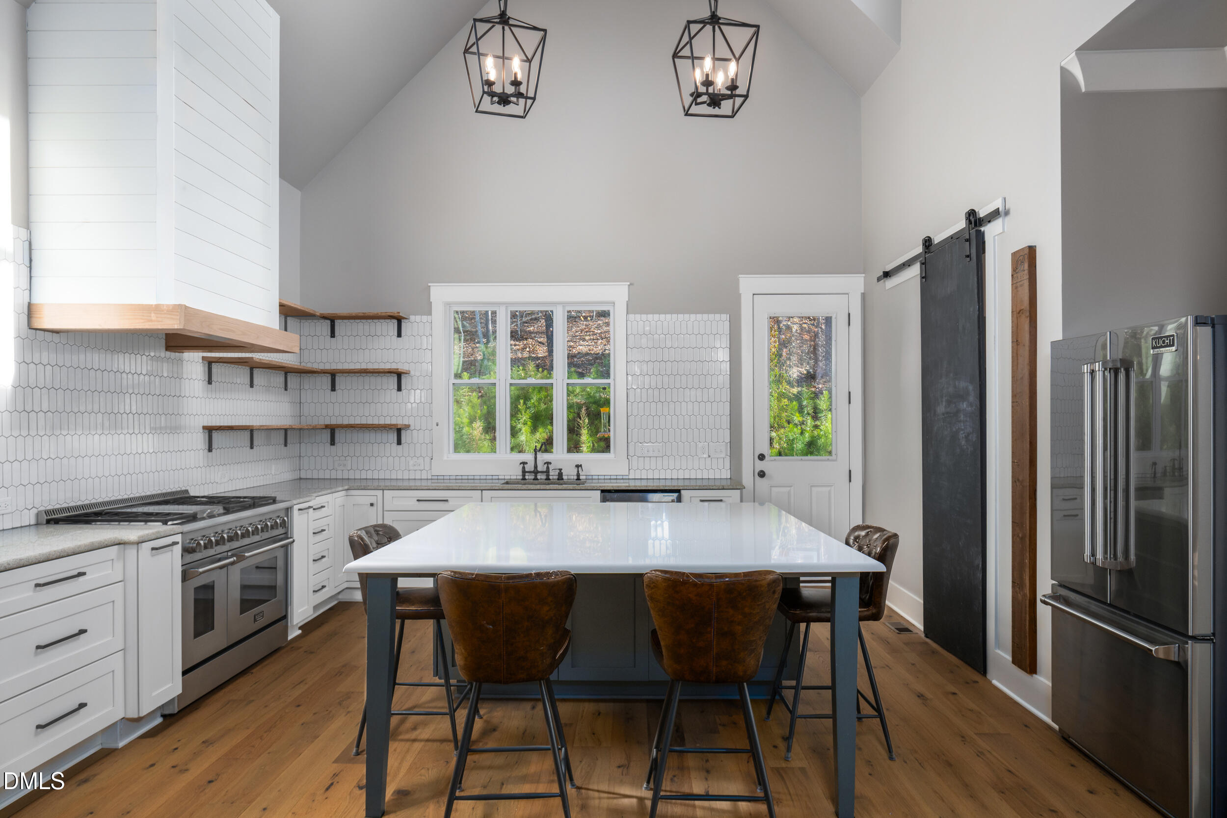 343 Deer Mountain Road Pittsboro, NC 27312 - Photo 5 of 55 a kitchen with stainless steel appliances granite countertop a stove a refrigerator a sink dishwasher with a dining table and chairs