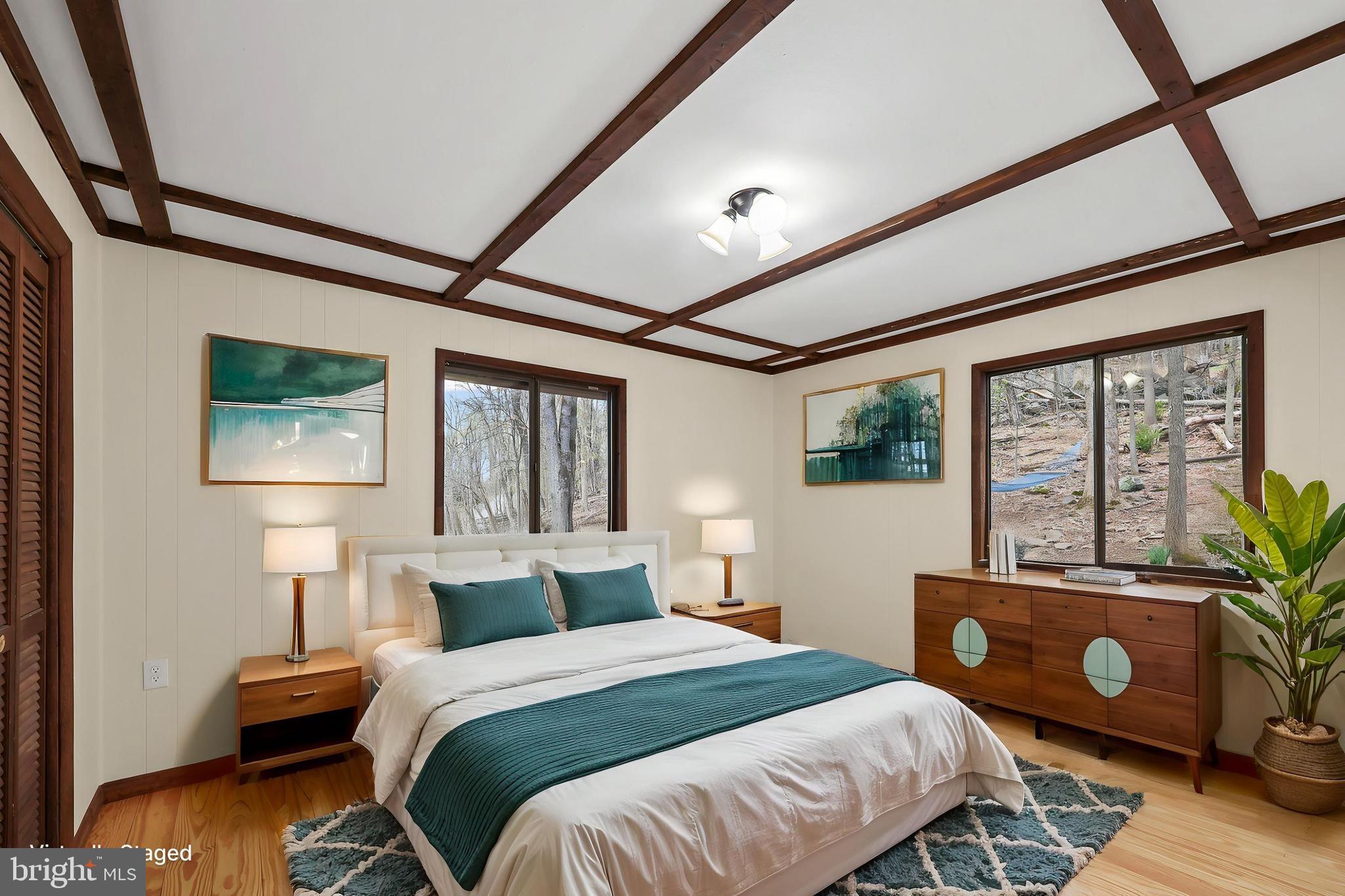 758 Club House Road Front Royal, VA 22630 - Photo 12 of 50 a bedroom with a bed a couch and a large window with wooden floor