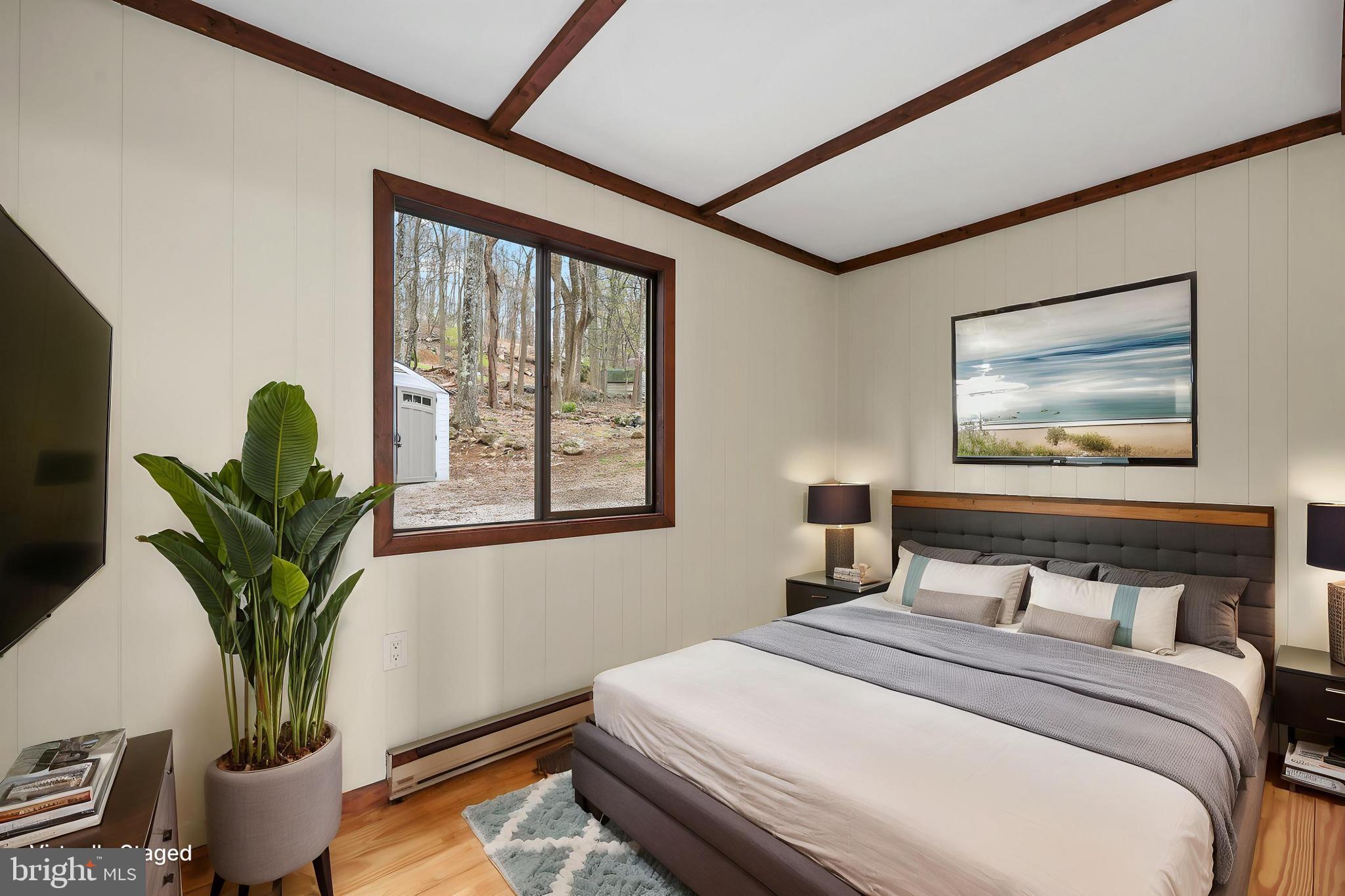 758 Club House Road Front Royal, VA 22630 - Photo 16 of 50 a bedroom with bed and a potted plant