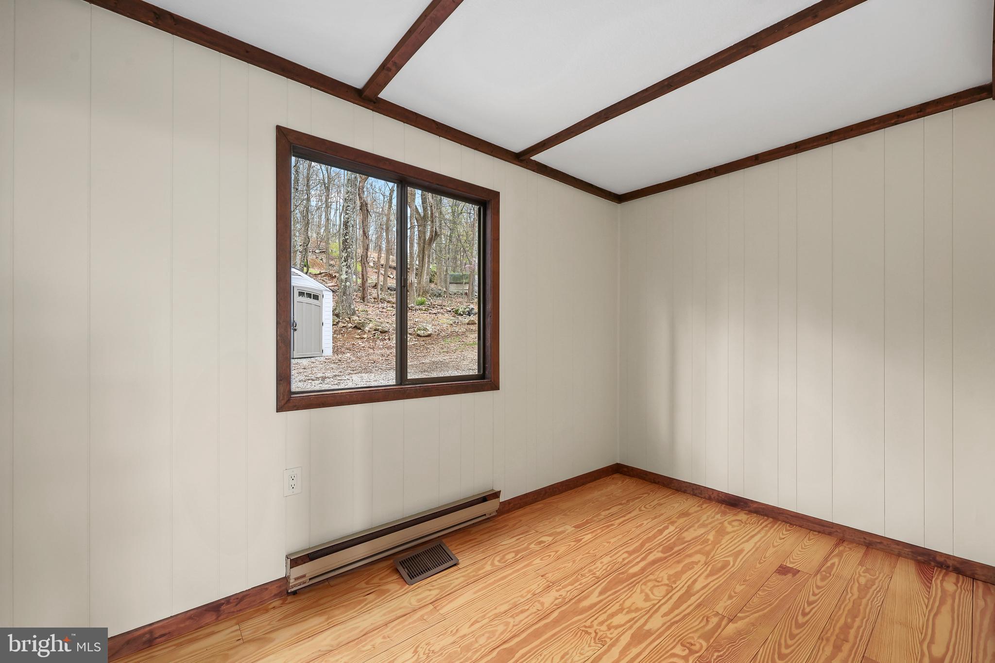758 Club House Road Front Royal, VA 22630 - Photo 17 of 50 a view of empty room with wooden floor and fan