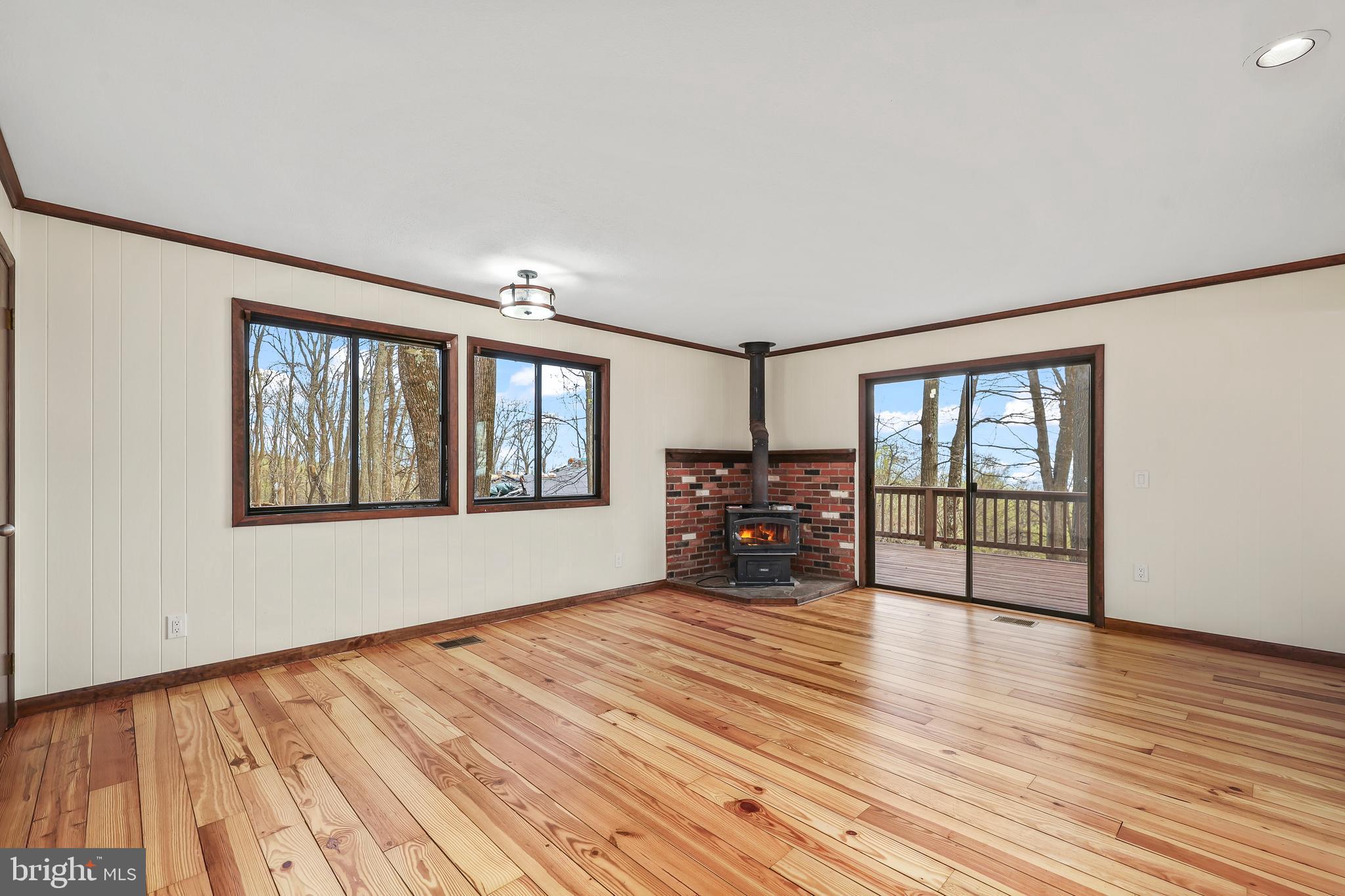 758 Club House Road Front Royal, VA 22630 - Photo 6 of 50 a view of an empty room with window and wooden floor