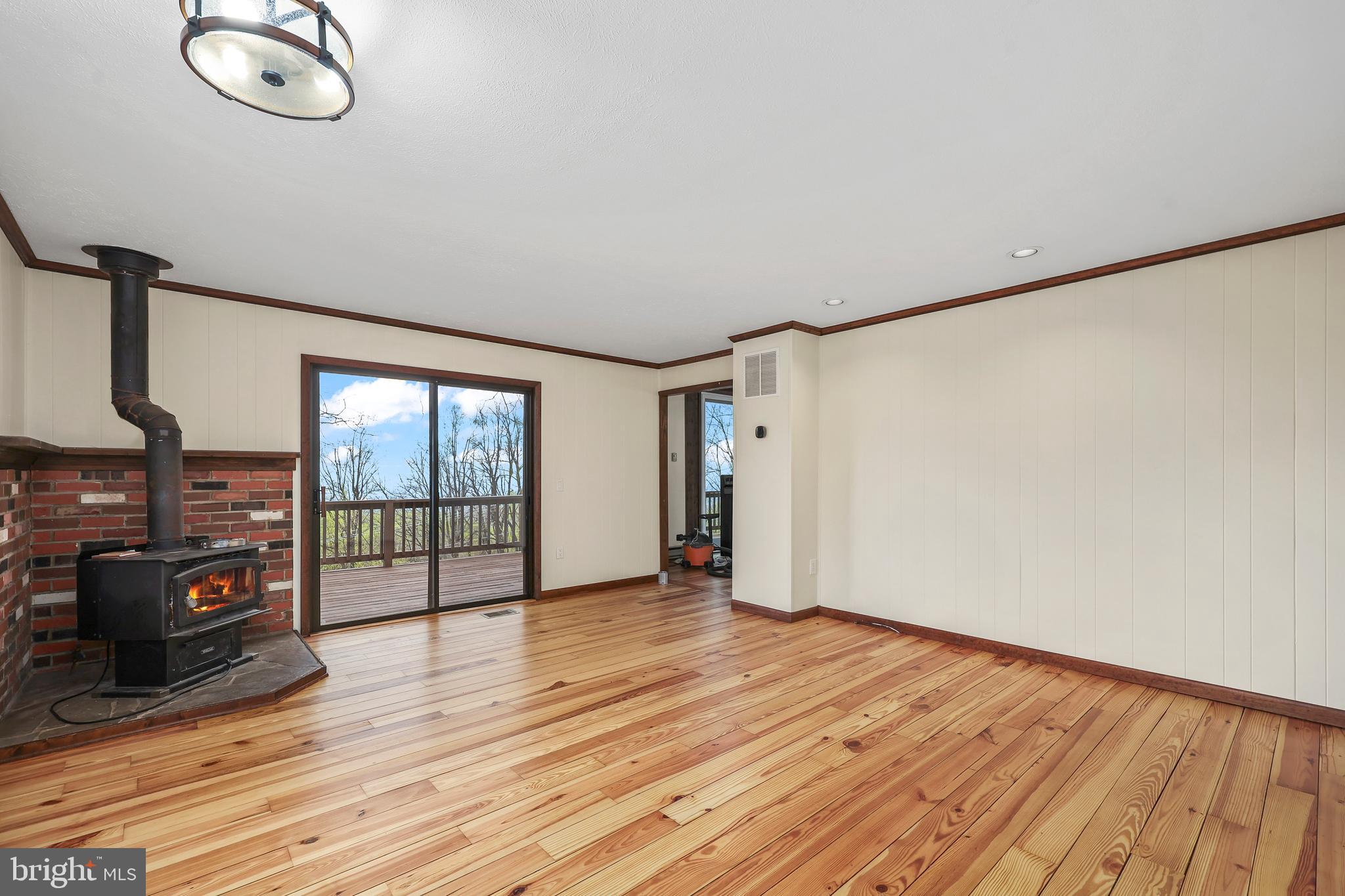 758 Club House Road Front Royal, VA 22630 - Photo 7 of 50 an empty room with wooden floor and windows