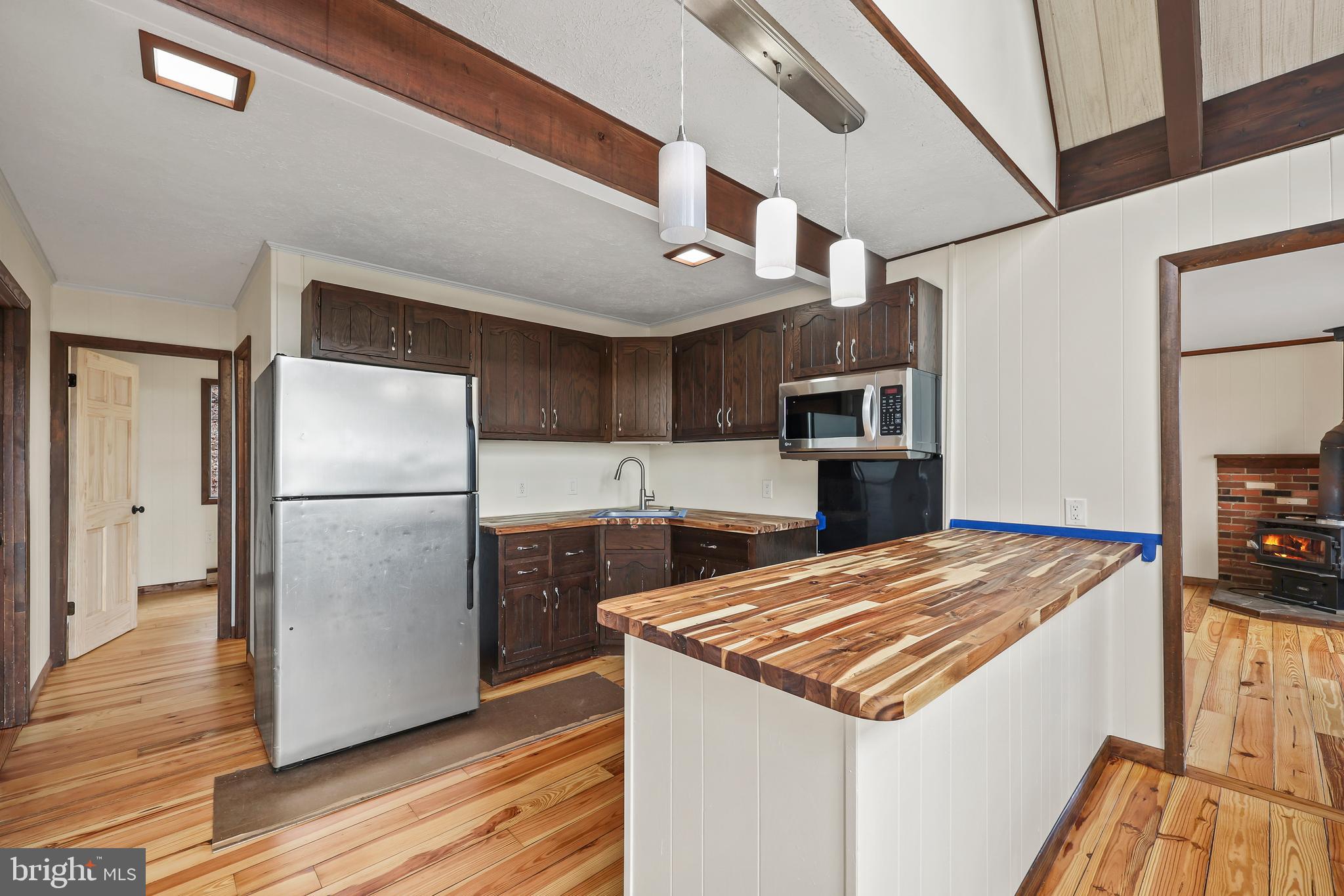 758 Club House Road Front Royal, VA 22630 - Photo 9 of 50 a kitchen with stainless steel appliances granite countertop a refrigerator a stove and a wooden floors