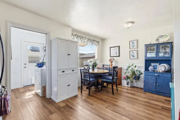 a view of a dining room with furniture and wooden floor