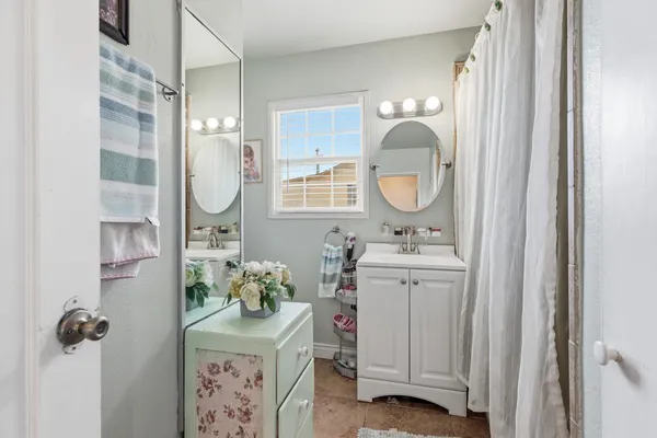 a bathroom with a sink mirror and vanity