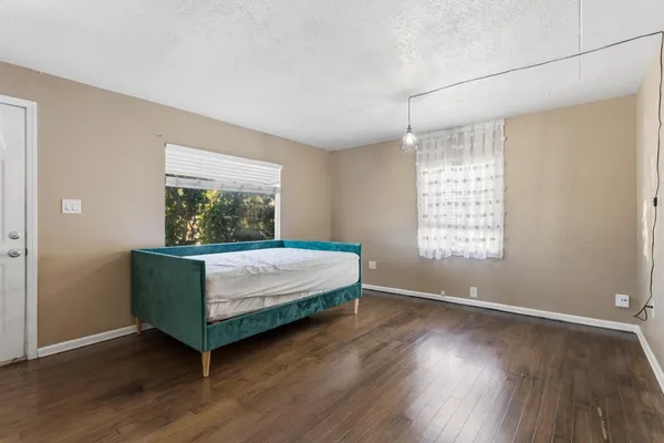 a bedroom with a bed and a window