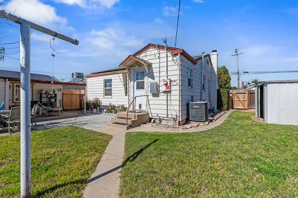 a view of a house with swimming pool and sitting area