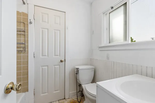 a white toilet sitting next to a bathroom sink