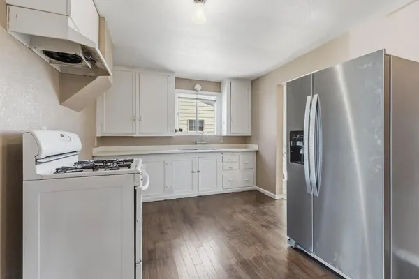 a kitchen with a stove a refrigerator and a sink