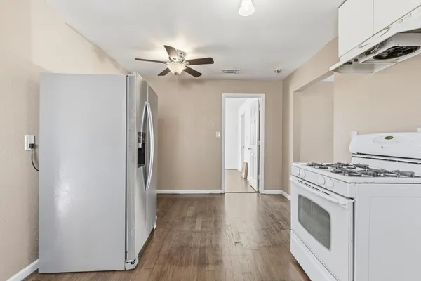a view of a kitchen with a stove cabinets and wooden floor