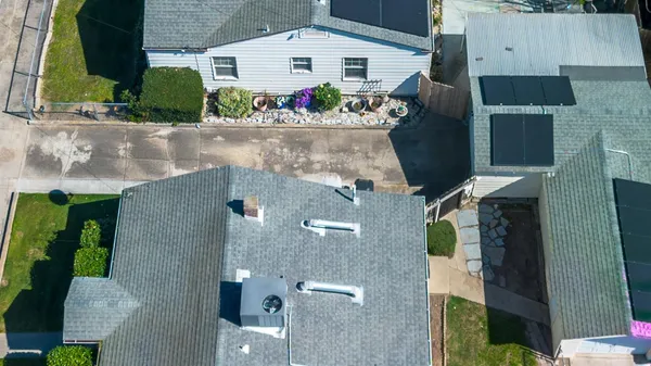 an aerial view of a house with a yard and potted plants