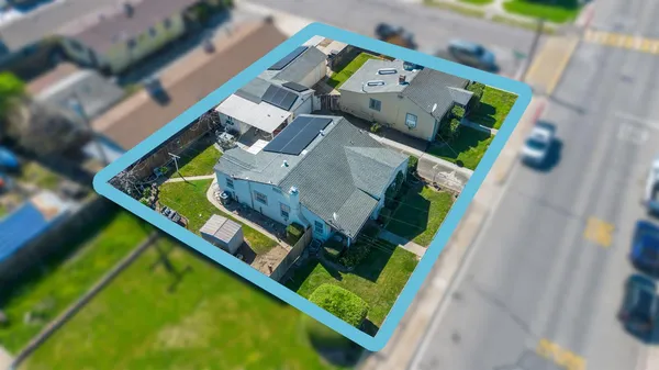 an aerial view of a house with a garden and trees