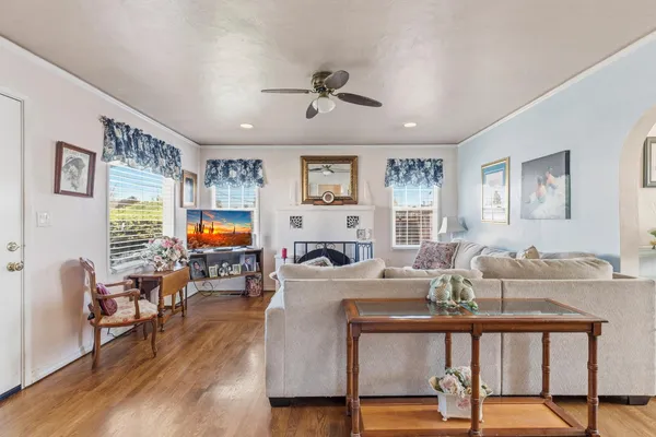 a living room with fireplace furniture and a flat screen tv