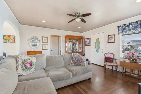 a living room with furniture and wooden floor
