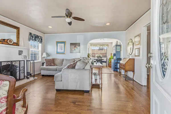 a living room with furniture or wooden floor and a large window