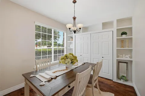 a dining room with furniture and window