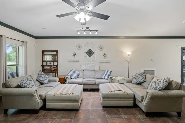 a living room with furniture or couch and a chandelier