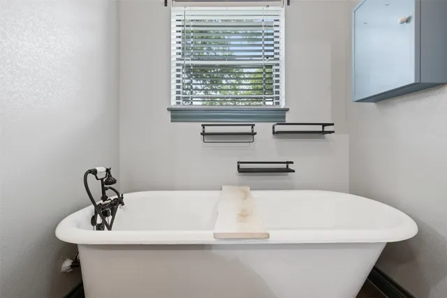 a bathroom with a sink and a window