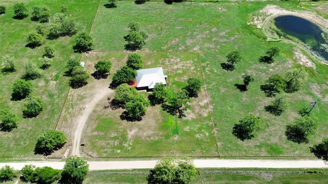 an aerial view of residential house with green space