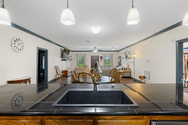 a living room with furniture pool table and chairs