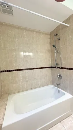 a bathroom with a bathtub and shower
