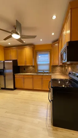 a kitchen with stainless steel appliances granite countertop a sink and a stove