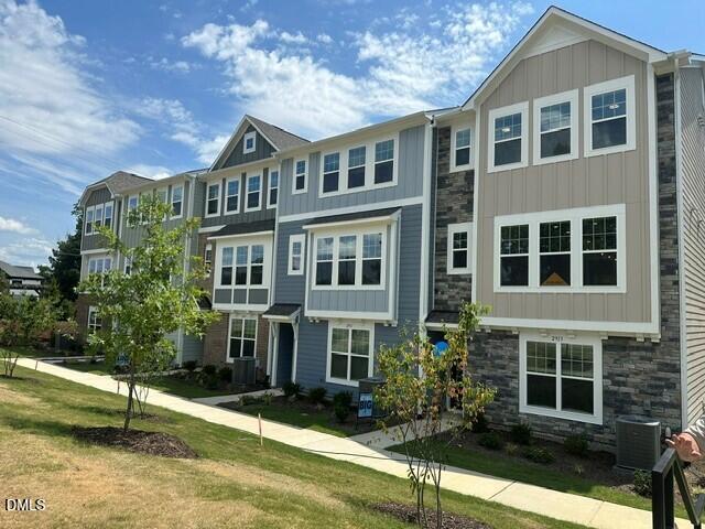 2913 Richardson Road, Unit 475 Apex, NC 27502 - Photo 1 of 24 a front view of a house with garden