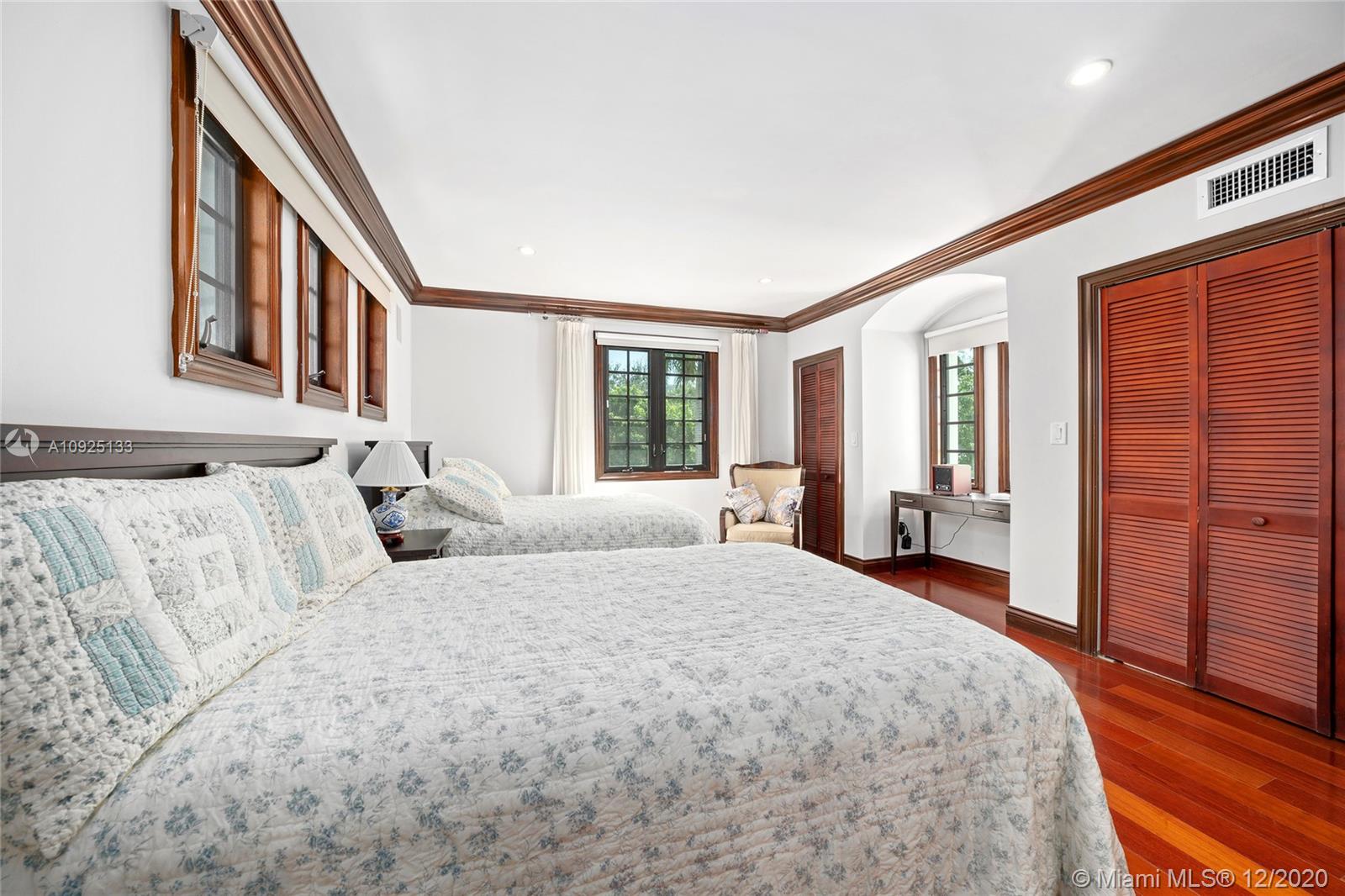 5300 Pine Tree Drive Miami Beach, FL 33140 - Photo 16 of 40 a spacious bedroom with a large bed and a window