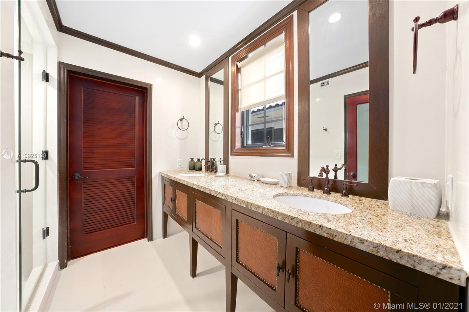 5300 Pine Tree Drive Miami Beach, FL 33140 - Photo 17 of 40 a bathroom with a granite countertop sink and a mirror