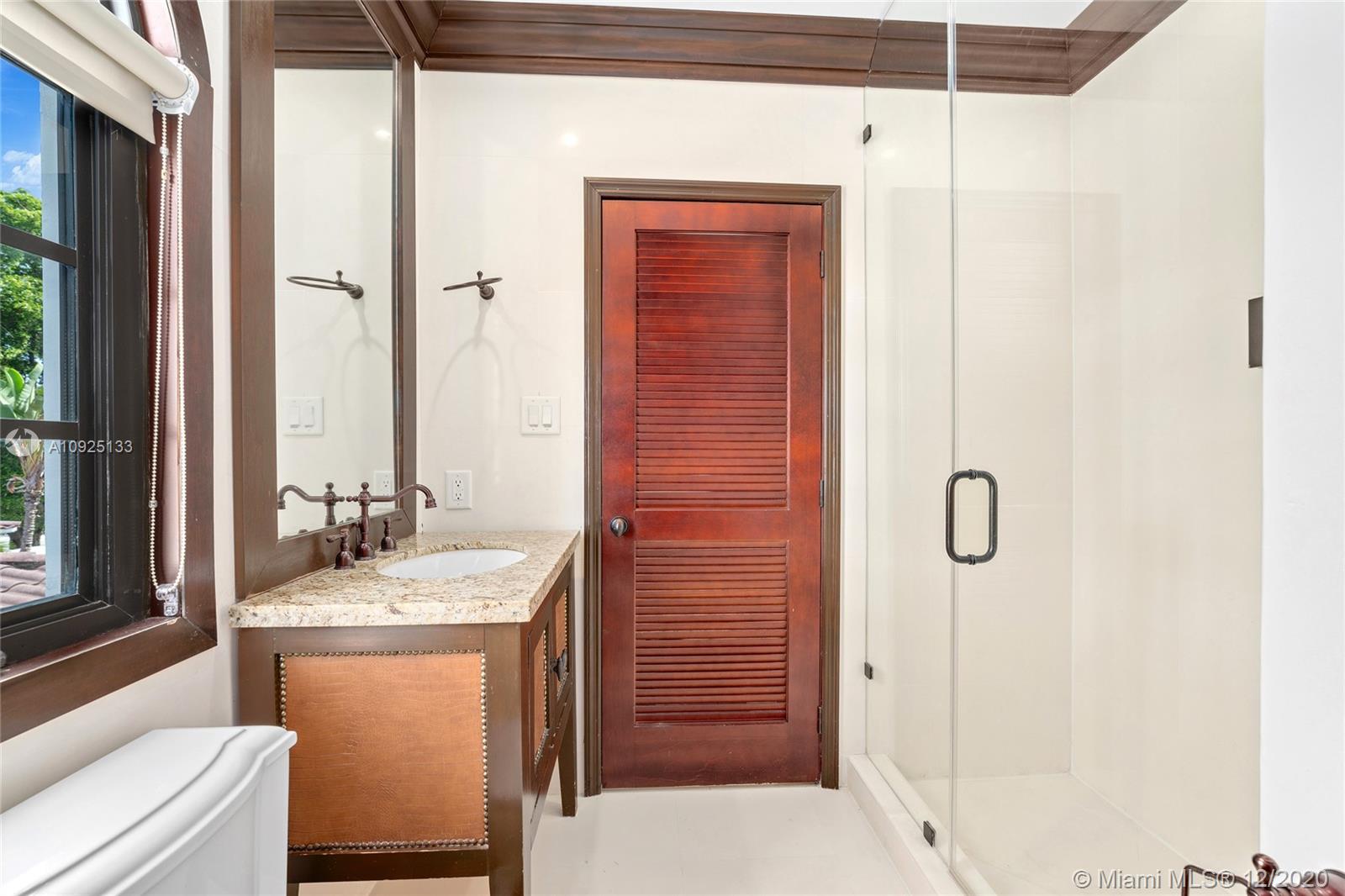 5300 Pine Tree Drive Miami Beach, FL 33140 - Photo 22 of 40 a bathroom with a sink a toilet and shower