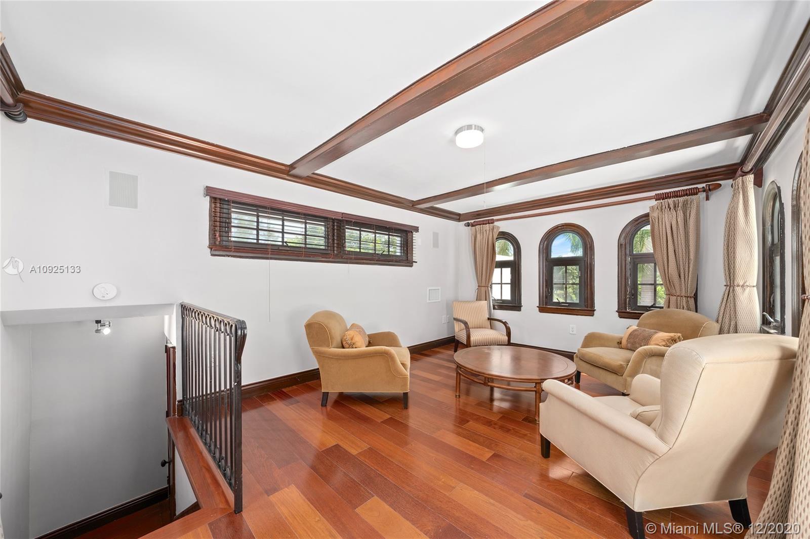 5300 Pine Tree Drive Miami Beach, FL 33140 - Photo 27 of 40 a living room with furniture and a large window