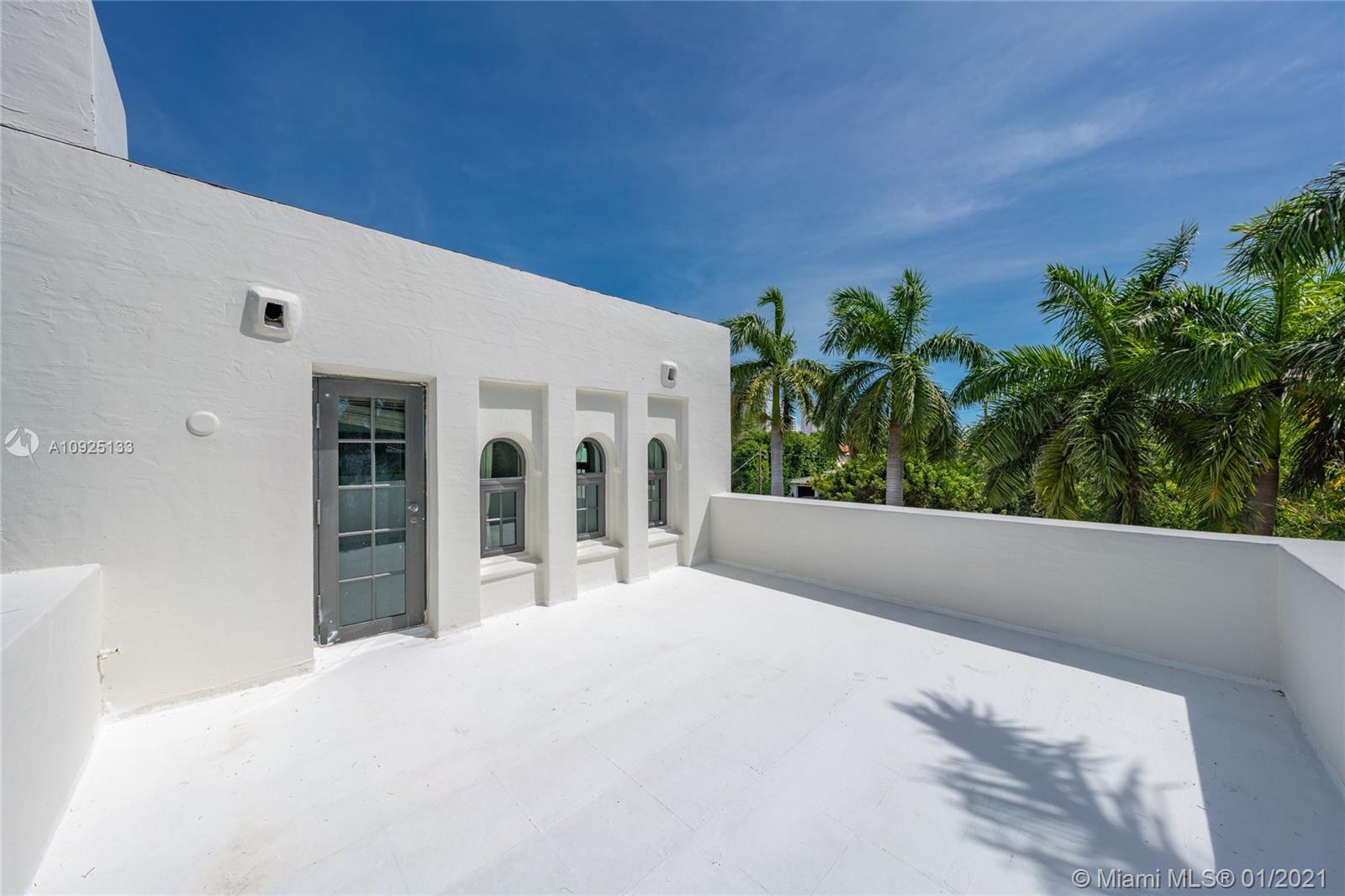 5300 Pine Tree Drive Miami Beach, FL 33140 - Photo 29 of 40 a view of a white house with a plants in front of it
