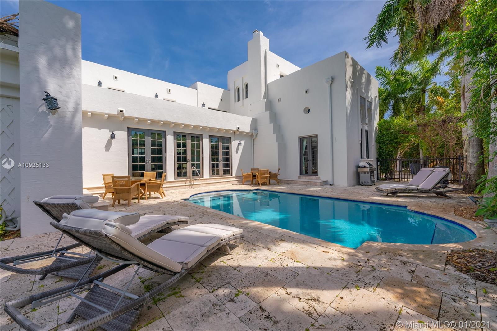5300 Pine Tree Drive Miami Beach, FL 33140 - Photo 35 of 40 a view of a patio with swimming pool table and chairs