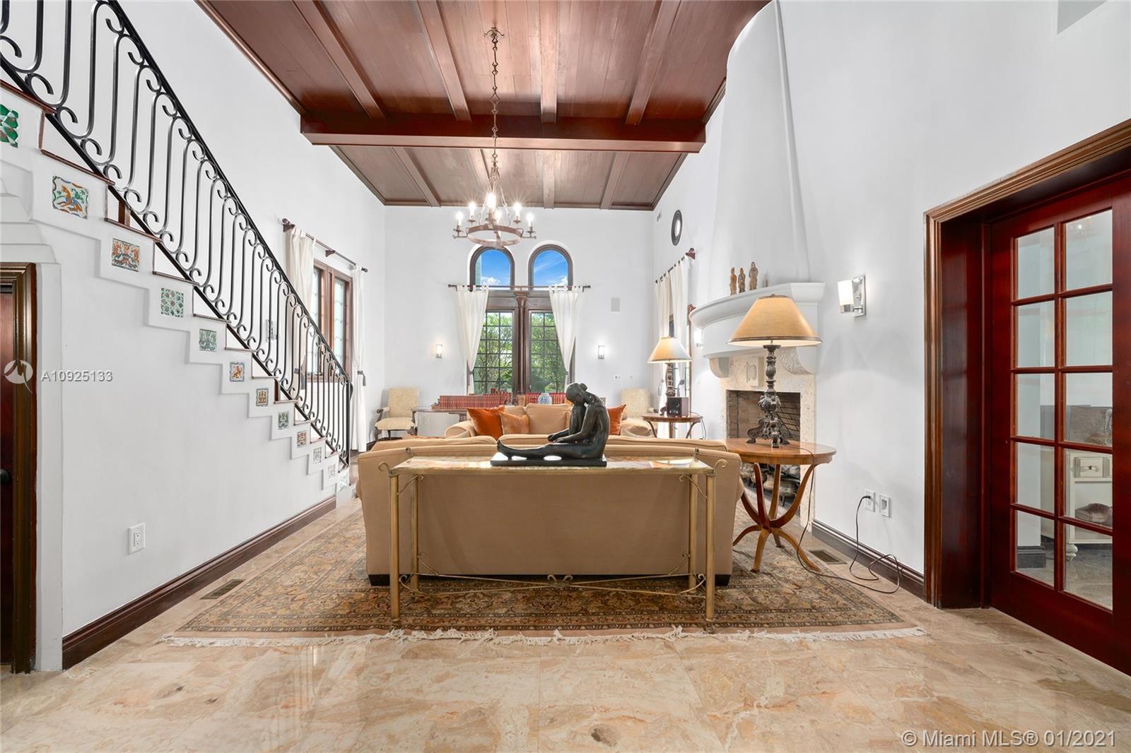 5300 Pine Tree Drive Miami Beach, FL 33140 - Photo 5 of 40 a living room with a couch and a table