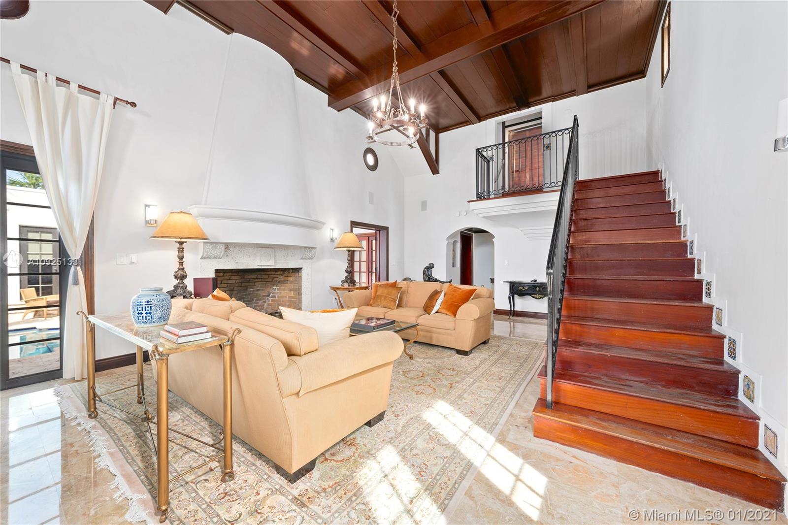 5300 Pine Tree Drive Miami Beach, FL 33140 - Photo 8 of 40 a living room with furniture and a fireplace