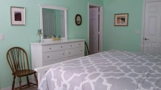 a bedroom with a bed and a lamp on table