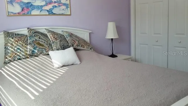 a bedroom with a bed and window