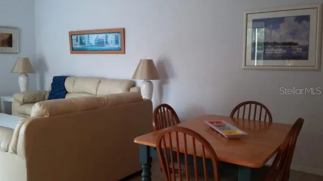 a living room with furniture chandelier and a window