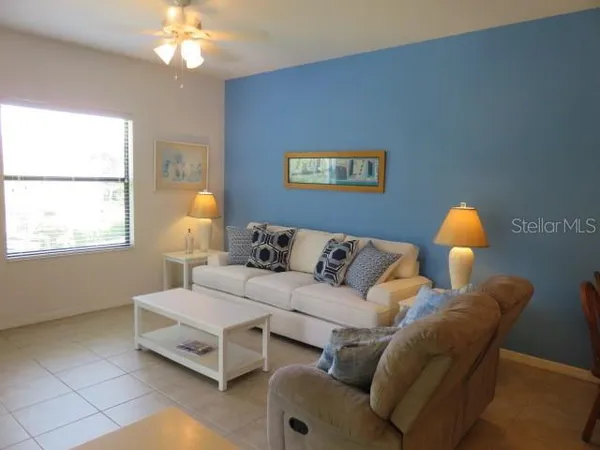 a living room with furniture and lamp