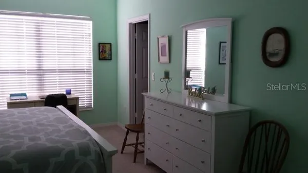 a bedroom with a bed and a mirror