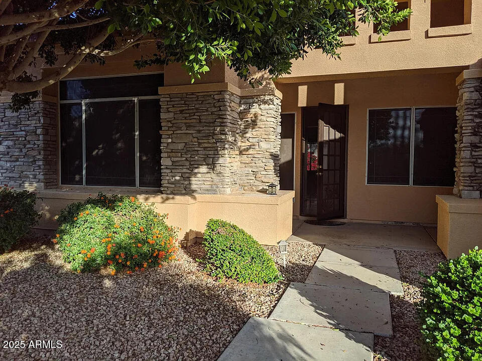 a view of a house with potted plants