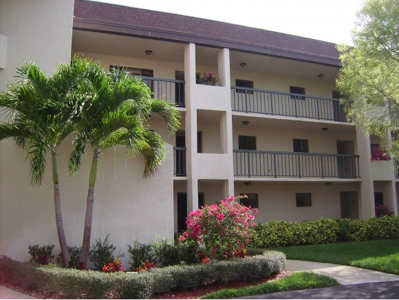 a front view of house and yard with green space