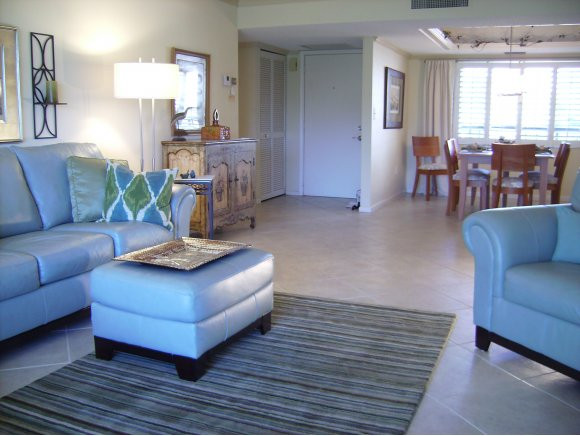 415 Augusta Boulevard, Unit 310 Naples, FL 34113 - Photo 2 of 15 a living room with furniture and a wooden floor