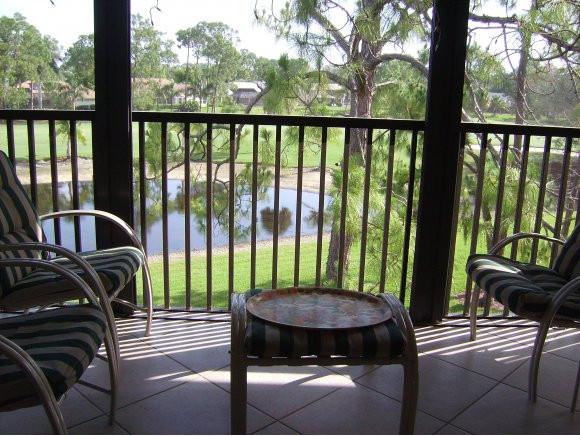 415 Augusta Boulevard, Unit 310 Naples, FL 34113 - Photo 11 of 15 a view of a balcony with furniture and a yard