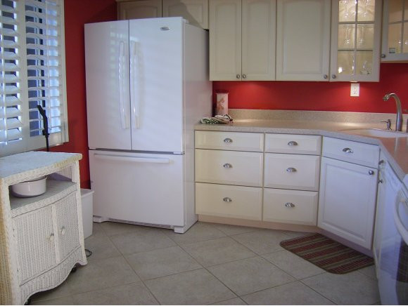 415 Augusta Boulevard, Unit 310 Naples, FL 34113 - Photo 4 of 15 a kitchen with cabinets and white appliances