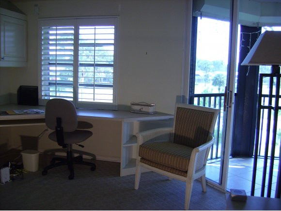 415 Augusta Boulevard, Unit 310 Naples, FL 34113 - Photo 10 of 15 a view of a workspace with furniture and a window