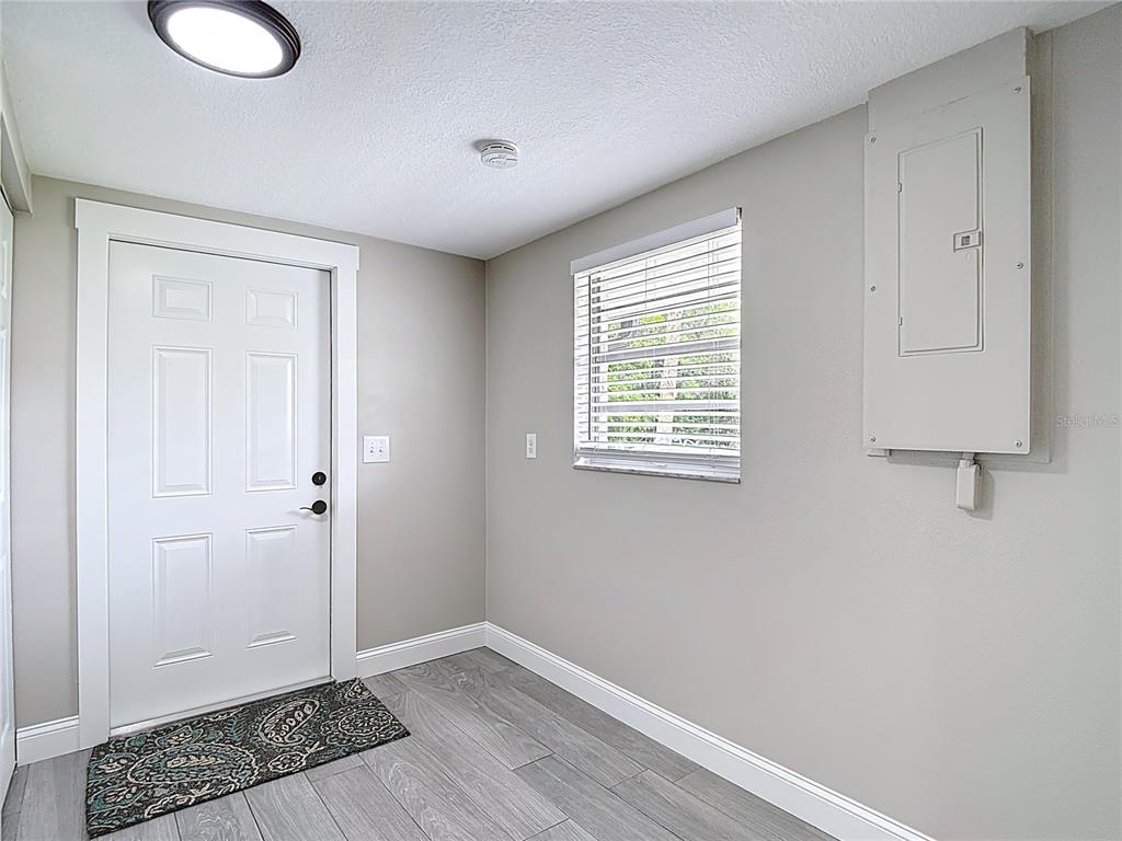 14306 Guava Street Hudson, FL 34667 - Photo 23 of 39 a view of an empty room with wooden floor and a window